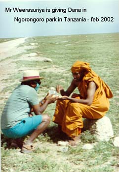 2002 February Mr Weerasooriya offering Dana at Ngorongoro national park in Tanzania.jpg